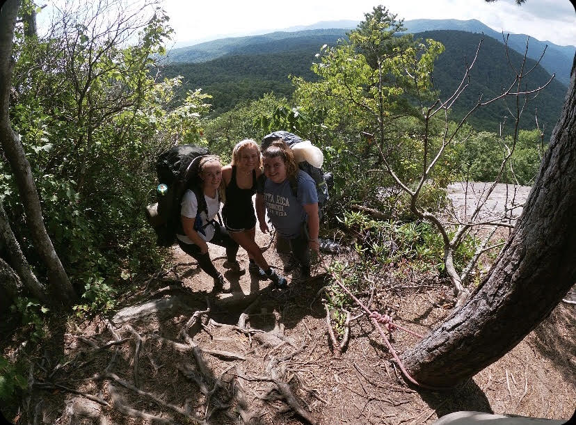 Juniors Sarah Henry, Alva Terho and Sayde Harrington-Moniz pause during a hike during a photo. Later on in the trip, the group was evacuated due to lightning. 