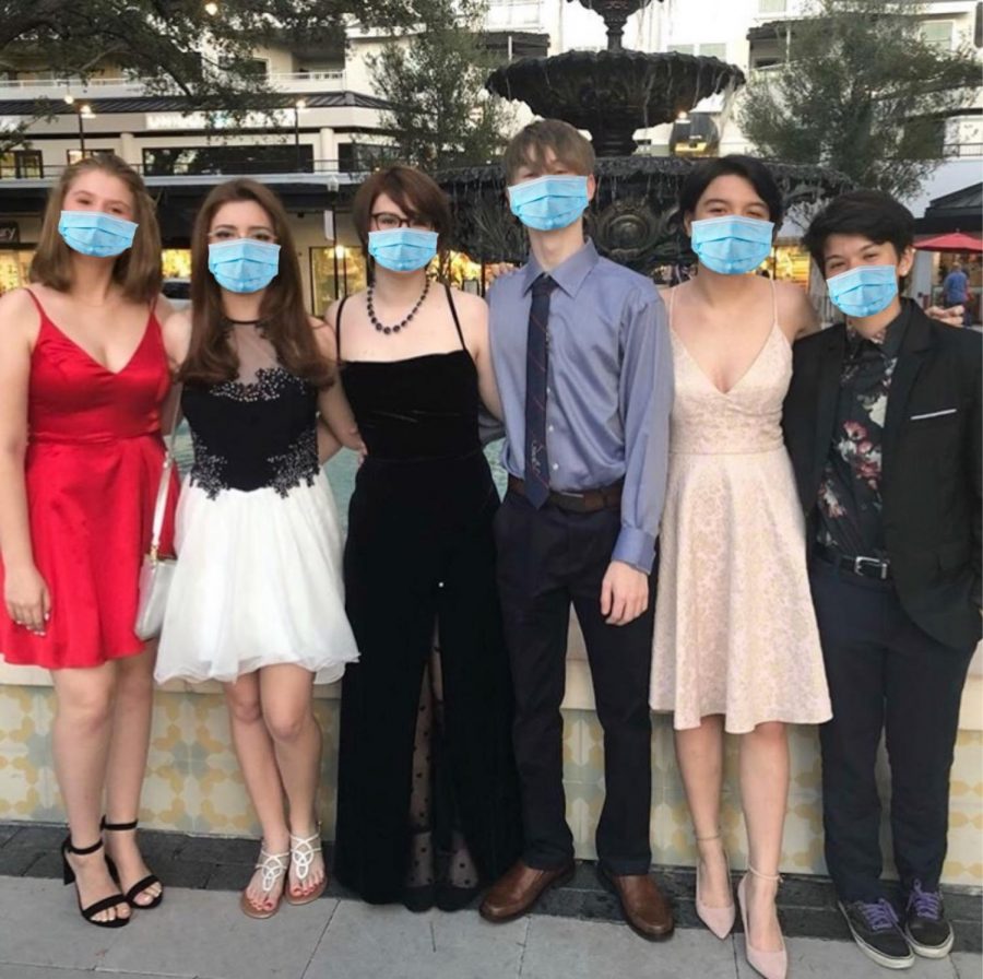 A+group+of+students+with+masks+edited+on%2C+pose+together+before+heading+to+the+2019+Homecoming+dance.%0A