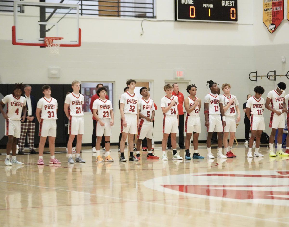 The team lines up in preparation for the singing of the star bangled banner 